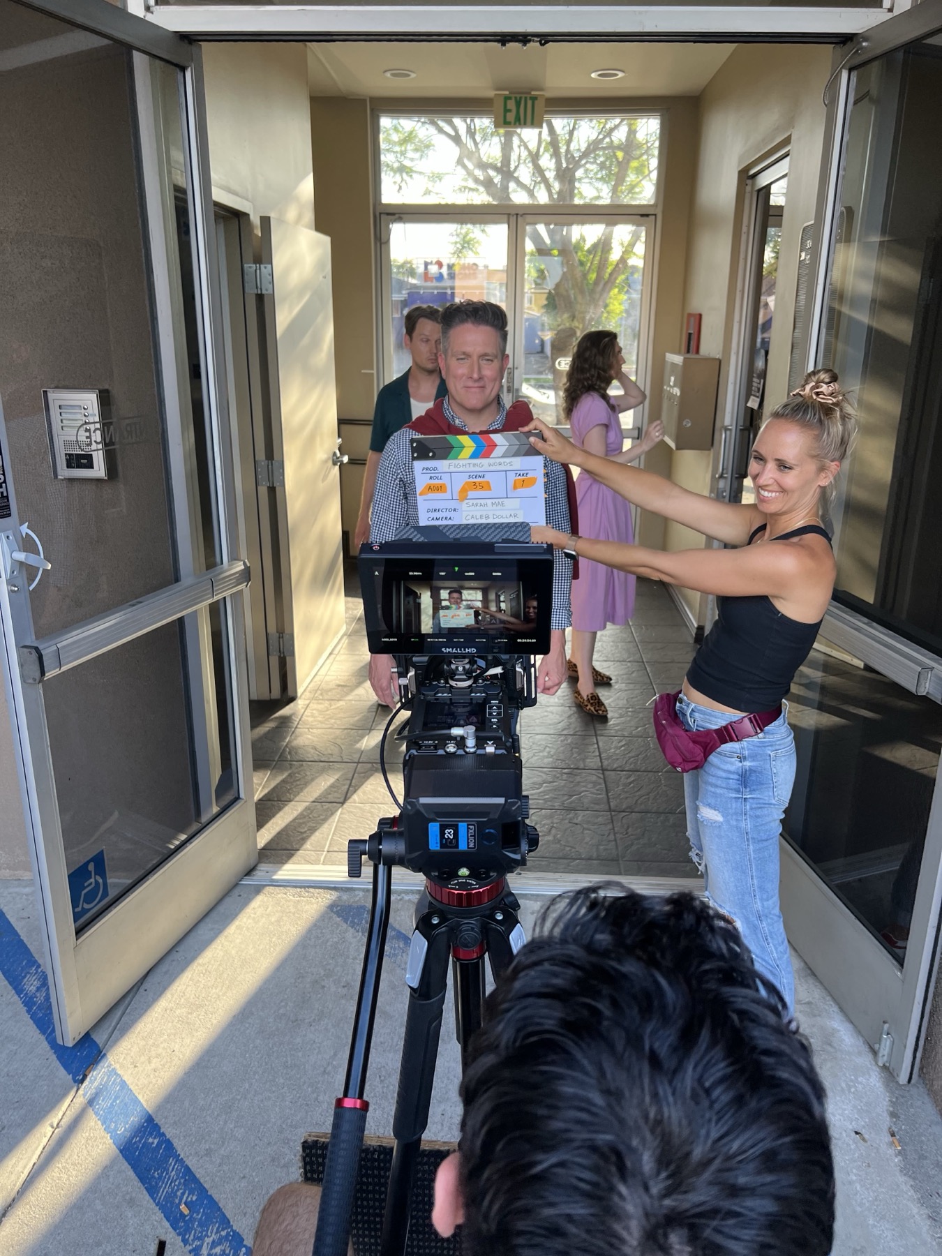 Crew marking a clapperboard before a take on a commercial set